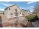 View of the home's backyard with natural stone landscaping and patio with blue skies at 15028 Clayton St, Thornton, CO 80602