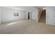 An open basement featuring neutral carpet with stairs to the main level and a basement window at 15028 Clayton St, Thornton, CO 80602
