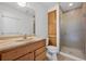 Bathroom featuring a single sink vanity, toilet, built-in storage and glass enclosed shower stall at 15028 Clayton St, Thornton, CO 80602