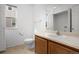 Neat bathroom features a toilet, sink, mirror, natural light, and tile flooring at 15028 Clayton St, Thornton, CO 80602