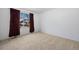 A clean, light bedroom with soft carpet has views of the neighborhood through the window at 15028 Clayton St, Thornton, CO 80602