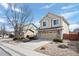 Two-story home with neutral siding and a two-car garage complemented by landscaped front yard at 15028 Clayton St, Thornton, CO 80602