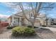 Two-story home with stone accents, a covered front porch, and manicured landscaping at 15028 Clayton St, Thornton, CO 80602