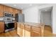 Updated kitchen features stainless appliances, an island, and beautiful wood floors at 15028 Clayton St, Thornton, CO 80602