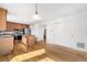 Open kitchen featuring hardwood floors, a center island, stainless appliances, and ample cabinetry at 15028 Clayton St, Thornton, CO 80602