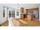 Bright open kitchen with stainless steel appliances, hardwood floors, and access to the patio at 15028 Clayton St, Thornton, CO 80602