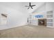 Bright open living room showcasing a fireplace, built-in shelves, and a large window at 15028 Clayton St, Thornton, CO 80602