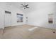 Spacious room with high ceilings and ample light showcasing neutral paint and soft carpet at 15028 Clayton St, Thornton, CO 80602