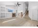 Bright living room featuring a fireplace, built-in shelving, and an open staircase at 15028 Clayton St, Thornton, CO 80602