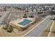 Aerial view of neighborhood pool with covered canopies, fences, and a bath house at 15028 Clayton St, Thornton, CO 80602
