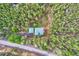 Overhead view of a house nestled in the woods with a long driveway at 11876 Coal Creek Heights Dr, Golden, CO 80403