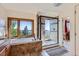 A soaking tub in a bathroom with large glass shower and a scenic outdoor view at 11876 Coal Creek Heights Dr, Golden, CO 80403