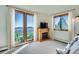 Bedroom with a view through large windows and an entertainment center with a fireplace at 11876 Coal Creek Heights Dr, Golden, CO 80403