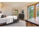 Cozy bedroom features a comfortable bed, stylish dresser, and a sunny window at 11876 Coal Creek Heights Dr, Golden, CO 80403