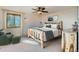 This bright bedroom features a rustic wooden bed frame, ceiling fan, and natural light at 11876 Coal Creek Heights Dr, Golden, CO 80403