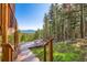 Inviting deck with picnic table, perfect for enjoying the surrounding forest views at 11876 Coal Creek Heights Dr, Golden, CO 80403
