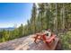 Scenic wood deck with a picnic table and beautiful views of the surrounding landscape at 11876 Coal Creek Heights Dr, Golden, CO 80403