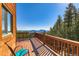 Enjoy the outdoors on this wood deck with a railing and beautiful mountain views in the distance at 11876 Coal Creek Heights Dr, Golden, CO 80403