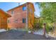 Charming home with a wooden exterior, featuring natural stone path and lush greenery at 11876 Coal Creek Heights Dr, Golden, CO 80403