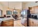 Modern kitchen featuring granite countertops, stainless steel refrigerator, and natural wood cabinets at 11876 Coal Creek Heights Dr, Golden, CO 80403