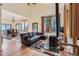 Spacious living room featuring hardwood floors, a fireplace, and seamless access to dining area at 11876 Coal Creek Heights Dr, Golden, CO 80403