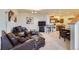 This living room features leather furniture, and an open floor plan connecting to the kitchen at 11876 Coal Creek Heights Dr, Golden, CO 80403