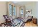 Cozy living room with rocking chair, chaise lounge, and plenty of natural light at 11876 Coal Creek Heights Dr, Golden, CO 80403