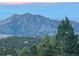 Scenic mountain view with a lush forest landscape underneath a colorful sky at 11876 Coal Creek Heights Dr, Golden, CO 80403