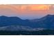 Majestic mountain range under a serene sky, framed by a dense forest in the foreground at 11876 Coal Creek Heights Dr, Golden, CO 80403