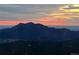 Enjoy a beautiful sunset over the mountains from this property's vantage point at 11876 Coal Creek Heights Dr, Golden, CO 80403