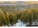 Expansive view of evergreen trees, mountains and sunset from this beautiful property in Evergreen, Colorado at 11876 Coal Creek Heights Dr, Golden, CO 80403