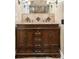 Bathroom boasts a wood vanity with granite counters, dual sinks, and decorative tile backsplash at 120 Cherokee St, Denver, CO 80223