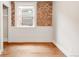 Bedroom featuring exposed brick and wood-trimmed window at 120 Cherokee St, Denver, CO 80223
