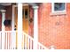 Close up of the entrance, featuring a wooden door, porch, and brick exterior at 120 Cherokee St, Denver, CO 80223