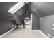 Bright, carpeted upper hallway beneath a skylight featuring gray walls and black wrought iron railings at 120 Cherokee St, Denver, CO 80223