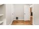 Hallway featuring hardwood floors and white paneled doors at 120 Cherokee St, Denver, CO 80223