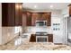 Well-appointed kitchen with stainless steel sink, oven, and dark wooden cabinets at 120 Cherokee St, Denver, CO 80223