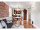 Inviting living room with exposed brick wall, wood floors, modern furniture, and stylish decor at 120 Cherokee St, Denver, CO 80223