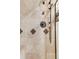 Close-up of the tiled shower with a mounted showerhead and decorative accents at 120 Cherokee St, Denver, CO 80223
