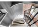 View of the staircase with gray walls, carpeted steps, and brick accents at 120 Cherokee St, Denver, CO 80223