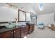 Bright bathroom featuring dual vanities with vessel sinks, skylight, and a vintage tub at 375 S University Blvd, Denver, CO 80209