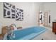 Bathroom featuring a light blue soaking tub with vintage fixtures and two windows at 375 S University Blvd, Denver, CO 80209