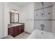 Bathroom with a large soaking tub, granite vanity, and decorative tile accents in the shower at 375 S University Blvd, Denver, CO 80209