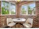 Cozy breakfast nook with brick walls, two windows and a marble-topped table at 375 S University Blvd, Denver, CO 80209