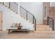 Contemporary foyer featuring open stairs, a hall bench, and wood floors for a welcoming entry at 375 S University Blvd, Denver, CO 80209