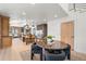 Gourmet kitchen featuring modern appliances, island seating, and an open dining area at 375 S University Blvd, Denver, CO 80209