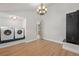 Spacious laundry room featuring side by side washer and dryer under modern lighting and hardwood flooring at 375 S University Blvd, Denver, CO 80209