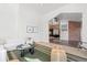 Open-concept living room flows into a dining area, highlighting the home's spacious layout at 375 S University Blvd, Denver, CO 80209