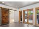 Bright living area boasts a sliding barn door and glass doors leading to an outdoor deck at 375 S University Blvd, Denver, CO 80209