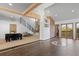 Spacious living area with an open staircase, brick accent wall, and access to an outdoor deck at 375 S University Blvd, Denver, CO 80209